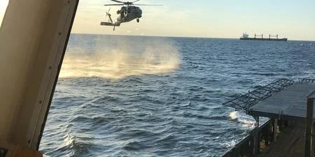 a helicopter flying over the water